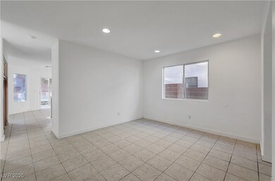 Spare room with baseboards, light tile patterned f