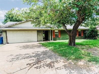 Ranch-style house featuring driveway, an attached garage, and brick siding