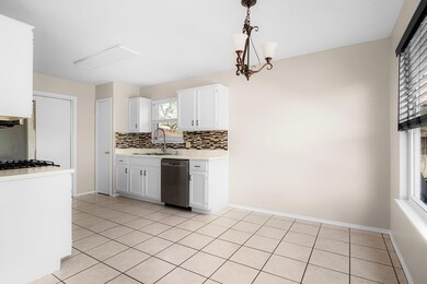Kitchen featuring stainless steel dishwasher, bac