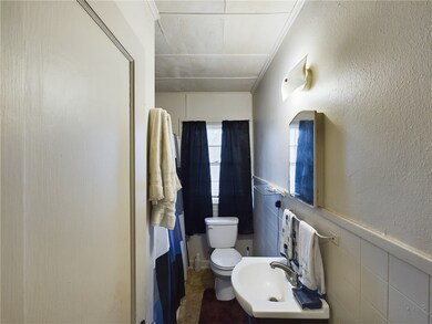 Bathroom with crown molding and wainscoting