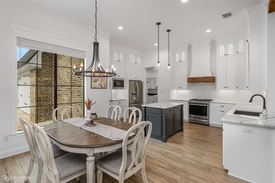 Dining space with light hardwood / wood-style floo