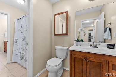 Bathroom featuring vanity, a shower with shower curtain, and light tile patterned floors
