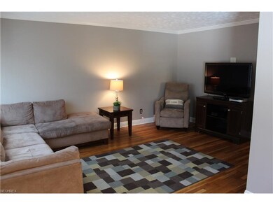 Living room with hardwood flooring, freshly painte