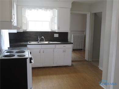 Crisp white cabinets with black countertop and bac
