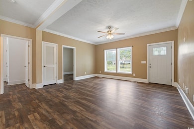 Unfurnished living room featuring dark wood-style 