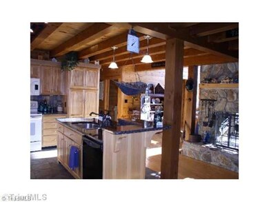 Kitchen. Granite countertops, hickory cabinets, pantry and custom tile backsplash and tile floor.