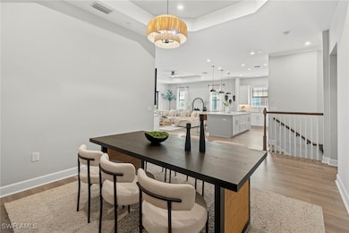 Dining area with light wood-type flooring and an i