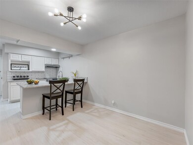 Kitchen featuring a breakfast bar area, white cabi