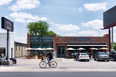View of commercial property featuring uncovered p