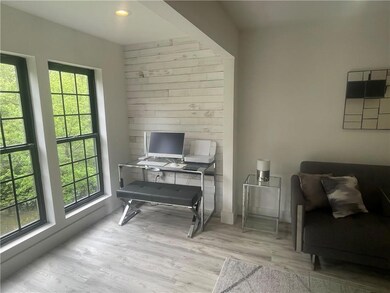 Home office with light wood-style floors and baseboards