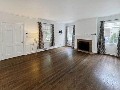 Unfurnished living room featuring dark hardwood / 