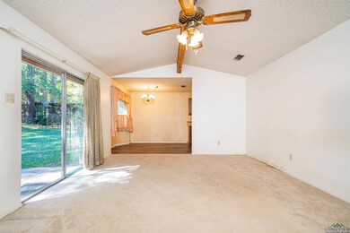Unfurnished room with a textured ceiling, lofted c