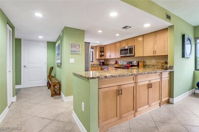 Kitchen with light brown cabinetry, light stone co