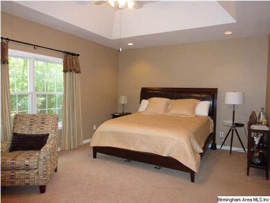 King sized master bedroom with vaulted tray ceilin