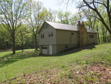 Back of house with garage door