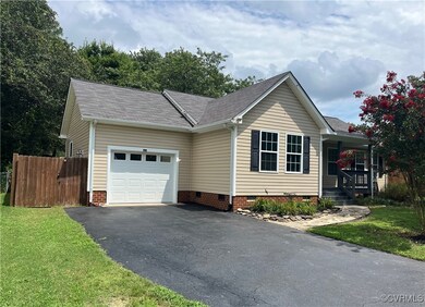 Single story home featuring a garage and a front lawn