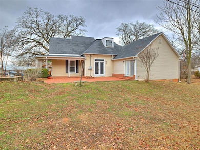Back of house featuring a yard
