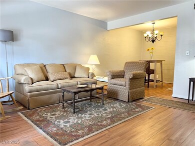 Living room with a notable chandelier and wood finished floors