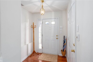 Foyer entrance featuring light wood-style flooring and baseboards