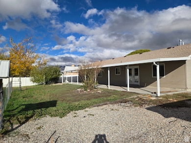 Back of house featuring a patio, french doors, and roof with shingles