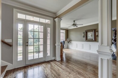 Front Entry Foyer with Natural Lighting & Formal Dining with recessed-panel wainscoting walls