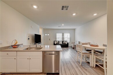 Kitchen with stainless steel dishwasher, white cab