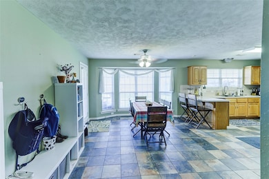 Dining room featuring a textured ceiling, baseboar