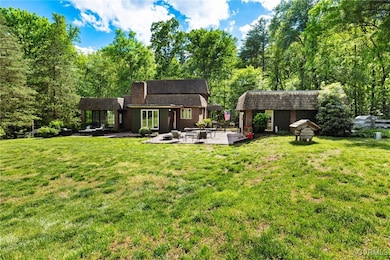 Back of house featuring a patio, a lawn, and a per