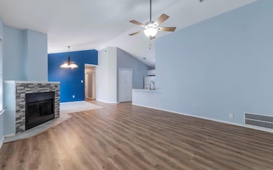 Unfurnished living room featuring lofted ceiling,