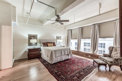 Large bedroom with floor to ceiling windows overlo
