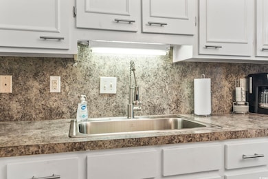 Kitchen featuring dark countertops, tasteful backs