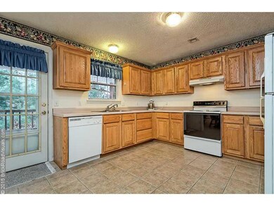 Kitchen. Open Kitchen w/tons of custom cabinets is perfect for the home cook! Also, easy access to the deck.