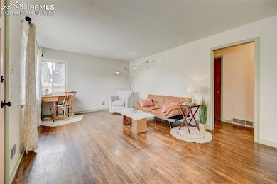 Living room featuring visible vents, wood finished