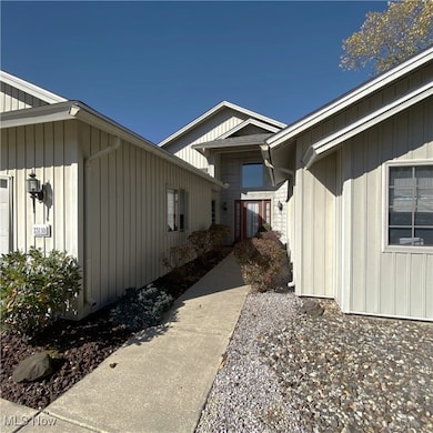 View of front of property with board and batten siding. Welcome in!