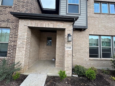 Doorway to property featuring brick siding