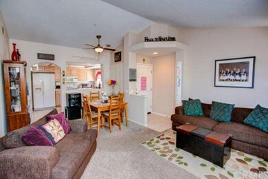 Living room, dining area, front door and kitchen