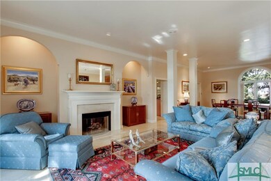 THE GAS FIREPLACE IN THE LIVING ROOM WITH ITS MARB