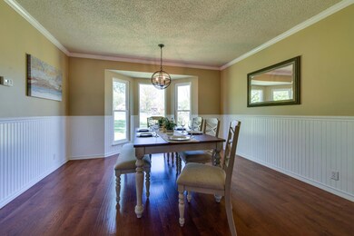 Spacious dining room with bay window looking out to back yard