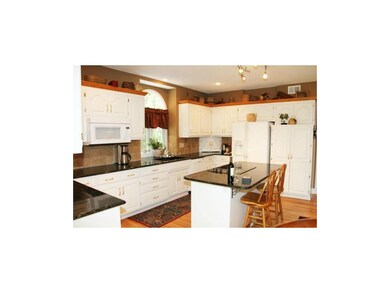 Open kitchen with island stove and granite counter