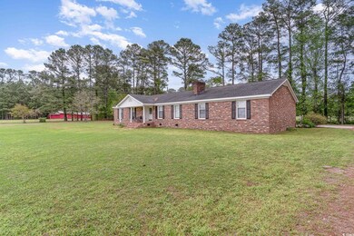 Ranch-style home featuring brick siding, a chimney