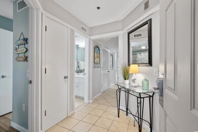 Hall featuring light tile patterned floors