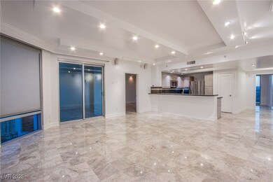 Unfurnished living room featuring a raised ceiling