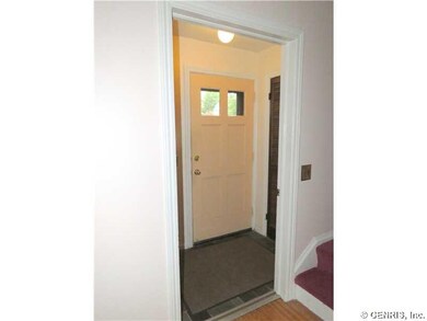 Foyer Front Entrance with Tile Floor and Guest Coa