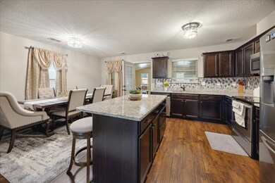 Kitchen featuring stainless steel appliances, tast