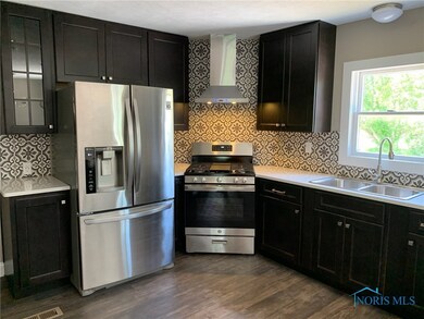 Kitchen with stainless hood and appliances