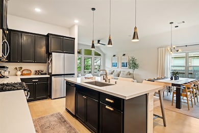 From the kitchen, the home opens into a spacious d