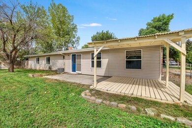 Rear view of property featuring a patio area and a chimney