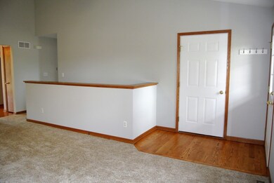 Vaulted ceiling in the family room. Open staircase