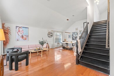 Living room with vaulted ceiling and hardwood / wo
