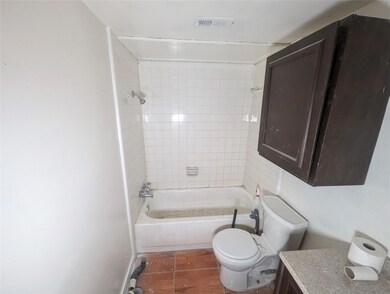 Full bathroom with wood-type flooring, tiled showe
